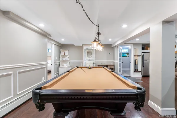 a room with pool table and windows