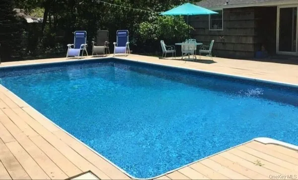 a backyard of a house with table and chairs