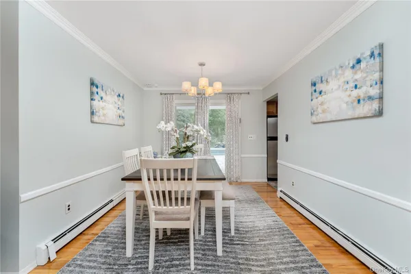a dining room with furniture and window