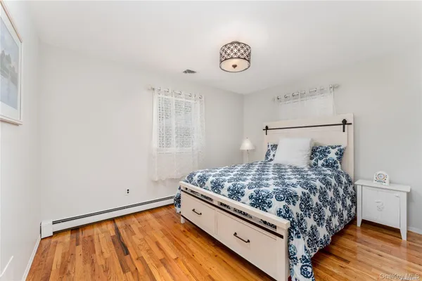 a bed sitting in a bedroom next to a window