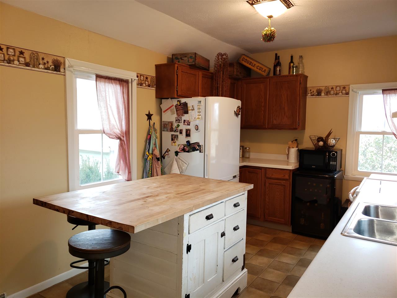 10410 North Church Road Davis, IL 61019 - Photo 18 of 25 a kitchen with refrigerator and wooden floor