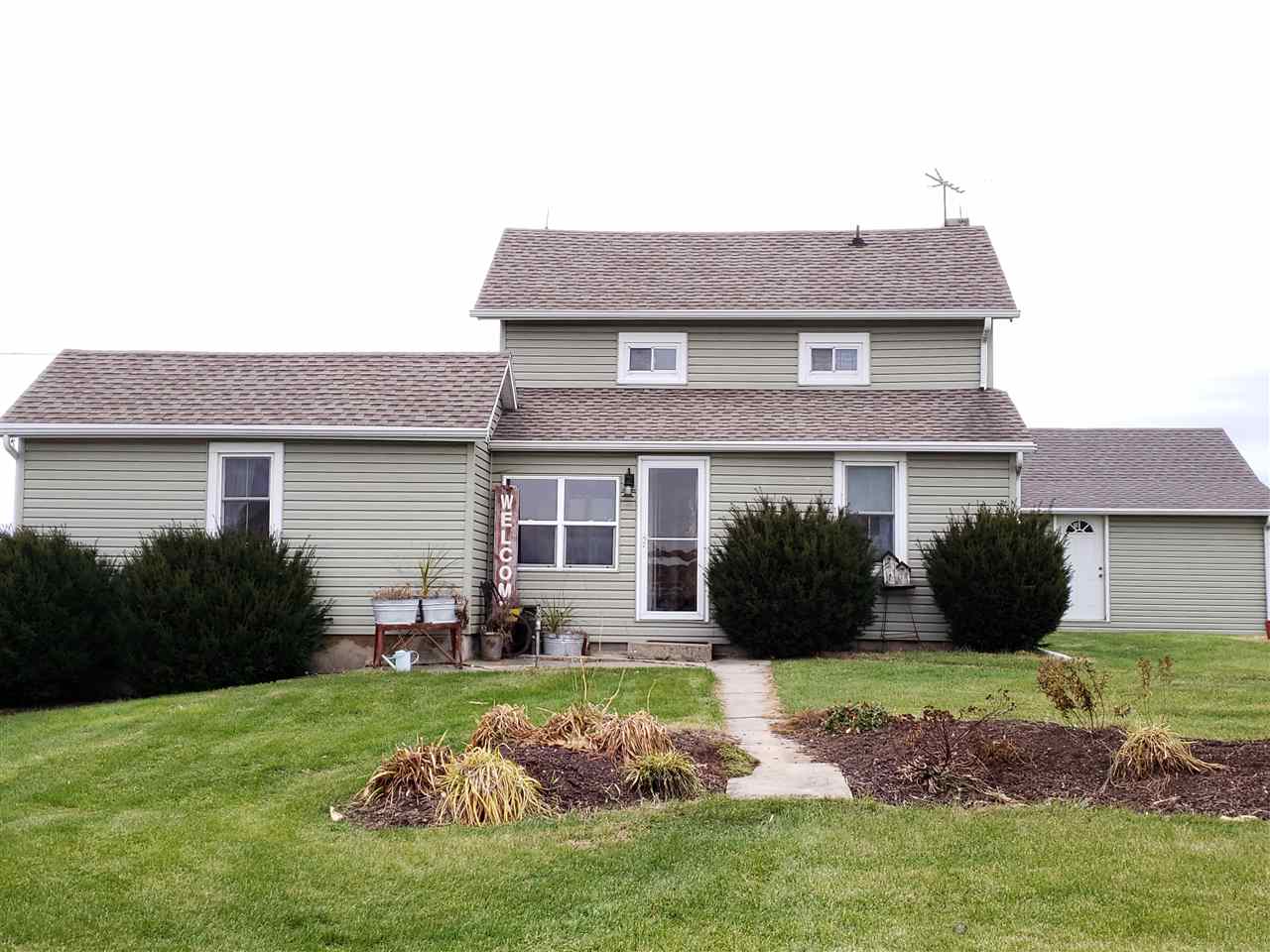 10410 North Church Road Davis, IL 61019 - Photo 22 of 25 a front view of a house with a garden