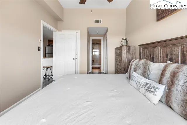 a view of a bedroom with furniture and closet