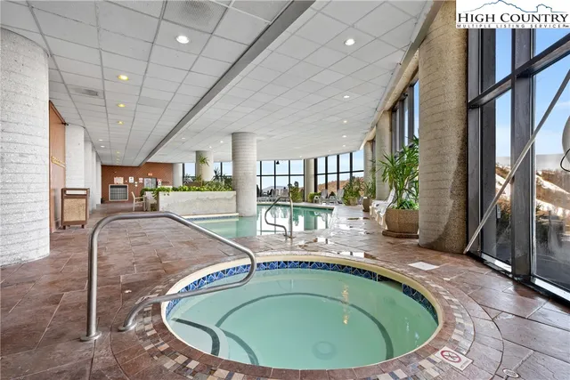 a view of a livingroom with furniture staircase and kitchen view
