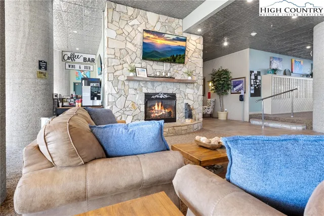 a living room with furniture fireplace and flat screen tv