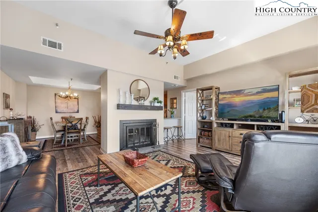 a living room with furniture a rug and a fireplace