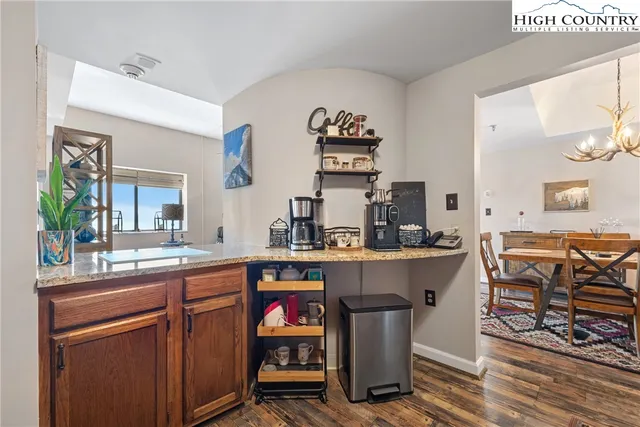 a kitchen with a sink and chairs