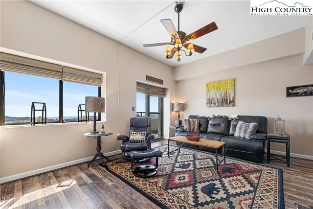 a living room with furniture a rug and a window