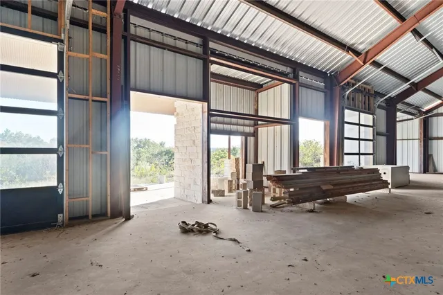 a living room with furniture and large windows