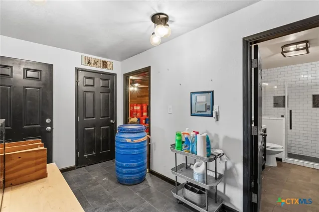 a dining room with furniture and a potted plant