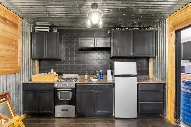 a kitchen with a refrigerator and a stove