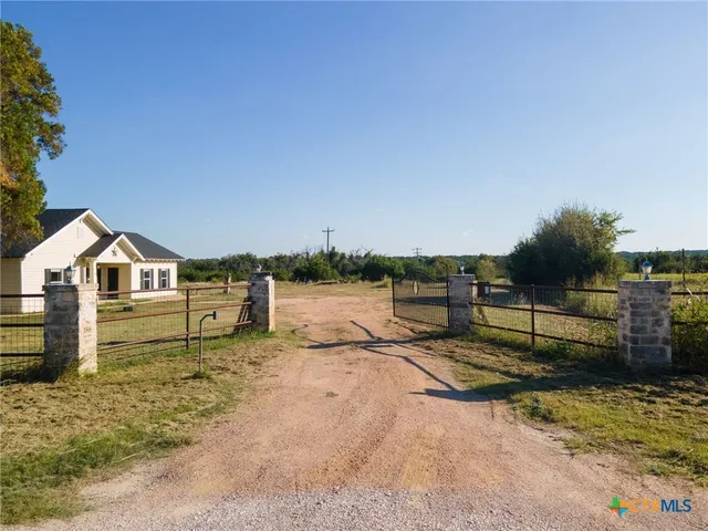 a view of a house with wooden fence