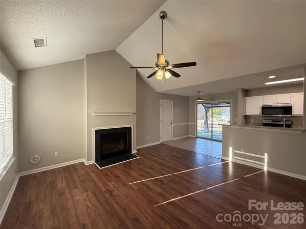 a view of a livingroom with a fireplace and window