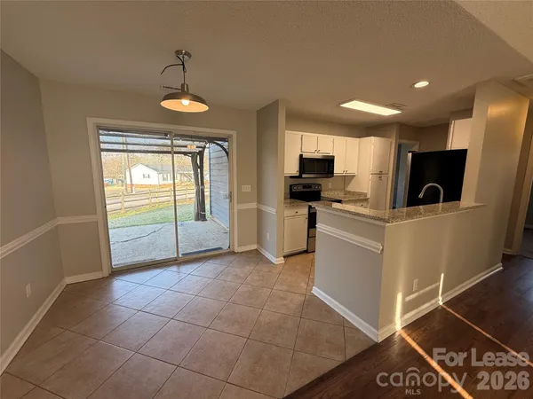 a kitchen with furniture and a window