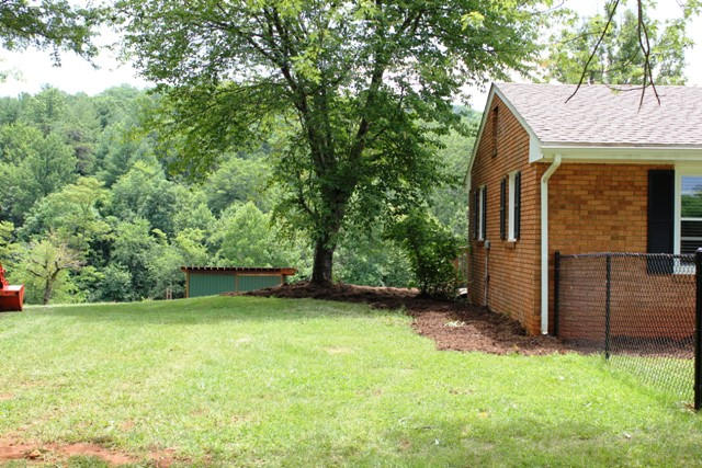 401 Monty Road Boones Mill, VA 24065 - Photo 30 of 30 a view of a backyard with a large tree