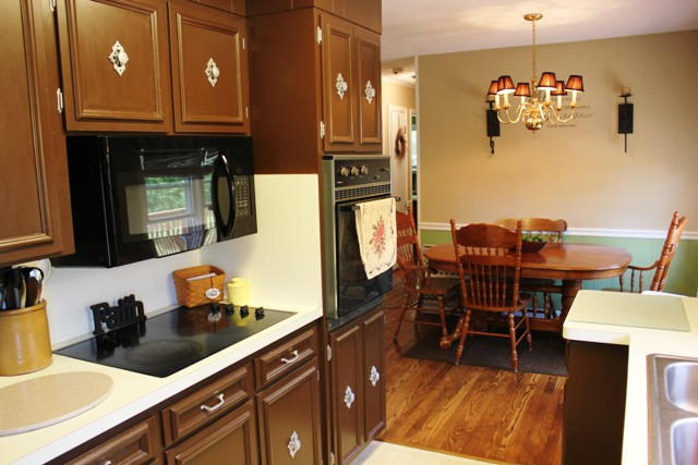 401 Monty Road Boones Mill, VA 24065 - Photo 9 of 30 a kitchen with stainless steel appliances kitchen island granite countertop a refrigerator a sink a dining table and chairs with wooden floor