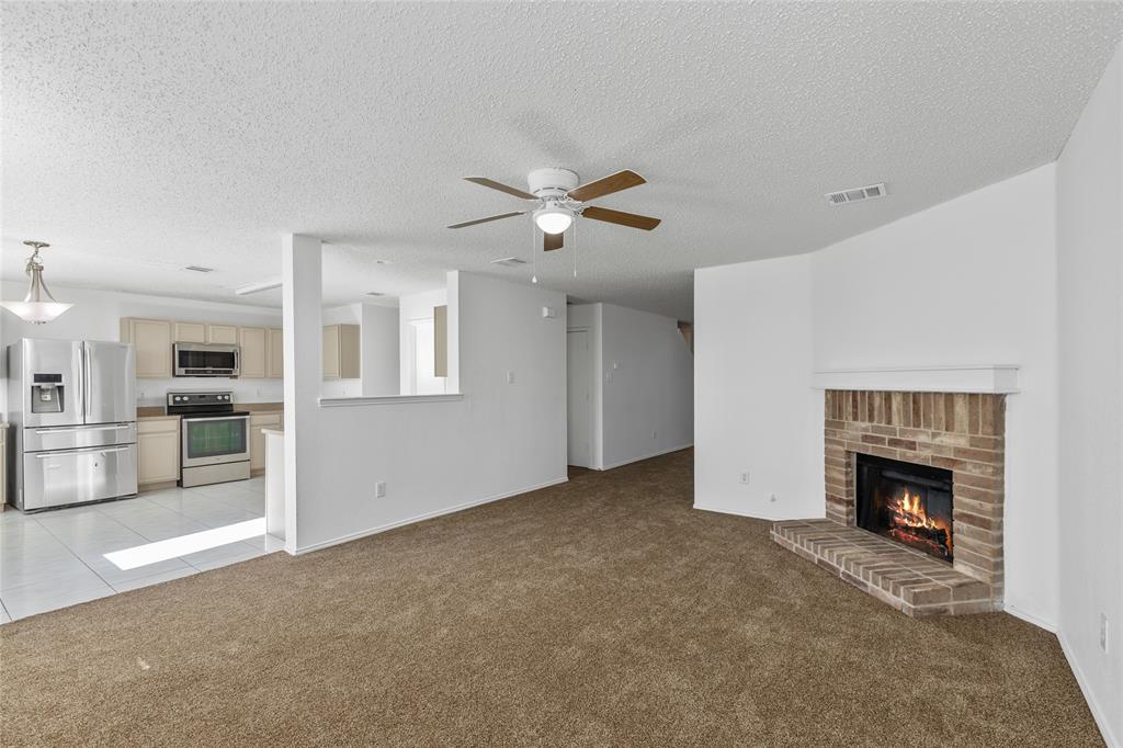 1628 Fieldstone Drive Little Elm, TX 75068 - Photo 11 of 32 a view of an empty room with a fireplace