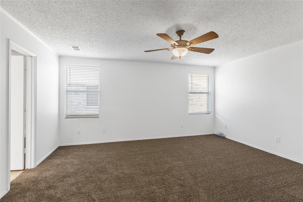 1628 Fieldstone Drive Little Elm, TX 75068 - Photo 15 of 32 an empty room with windows and fan