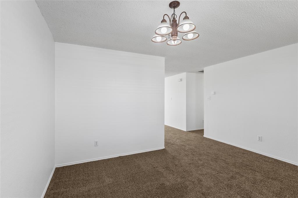 1628 Fieldstone Drive Little Elm, TX 75068 - Photo 8 of 32 a view of an empty room with a chandelier