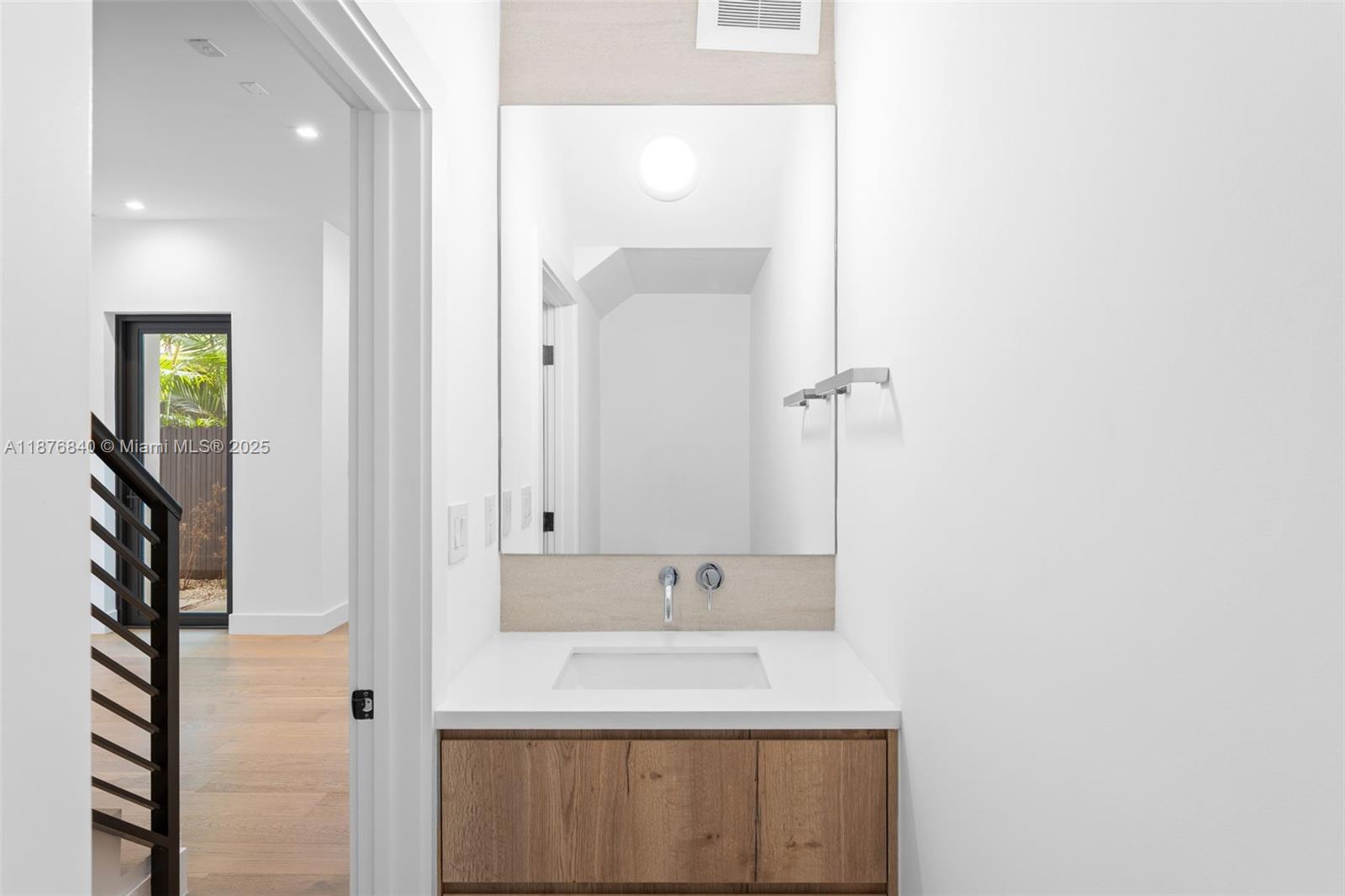 3132 Plaza Street Miami, FL 33133 - Photo 11 of 36 a bathroom with a sink and a mirror