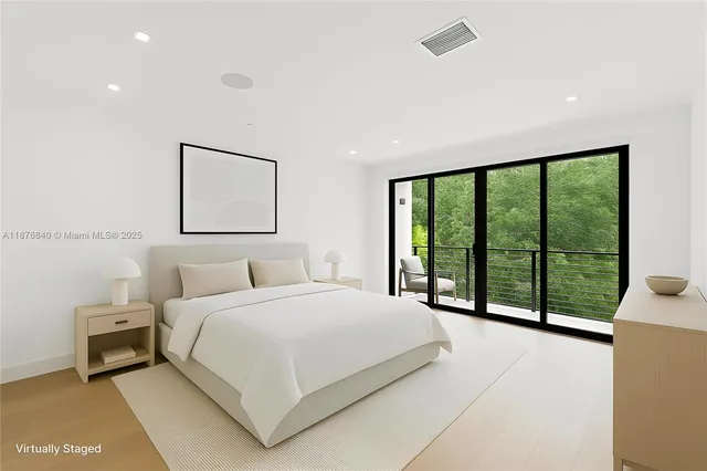 a bedroom with a large bed and a large window