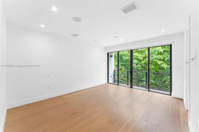 an empty room with large windows