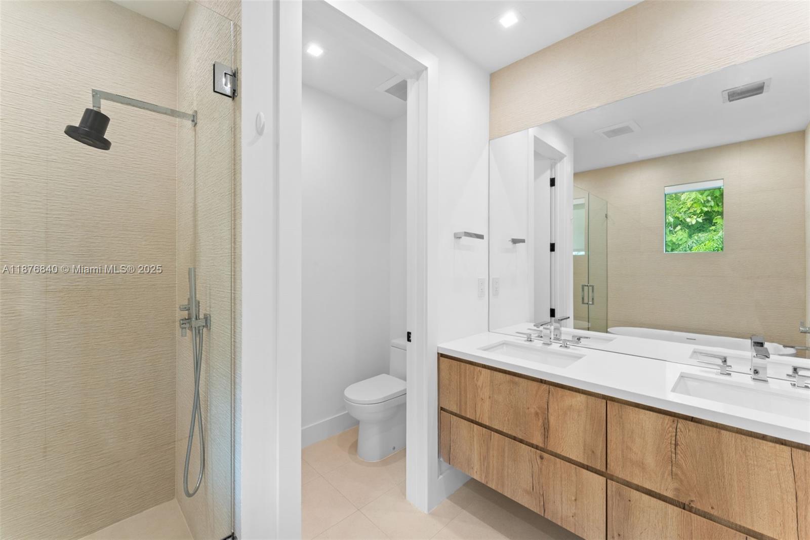 3132 Plaza Street Miami, FL 33133 - Photo 17 of 36 a bathroom with a double vanity sink toilet and shower