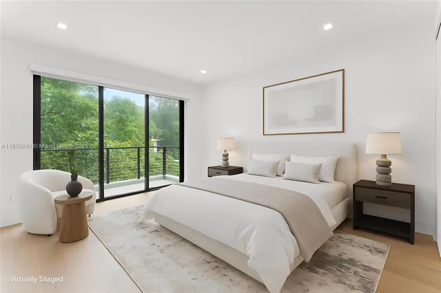 a bedroom with a bed and glass window