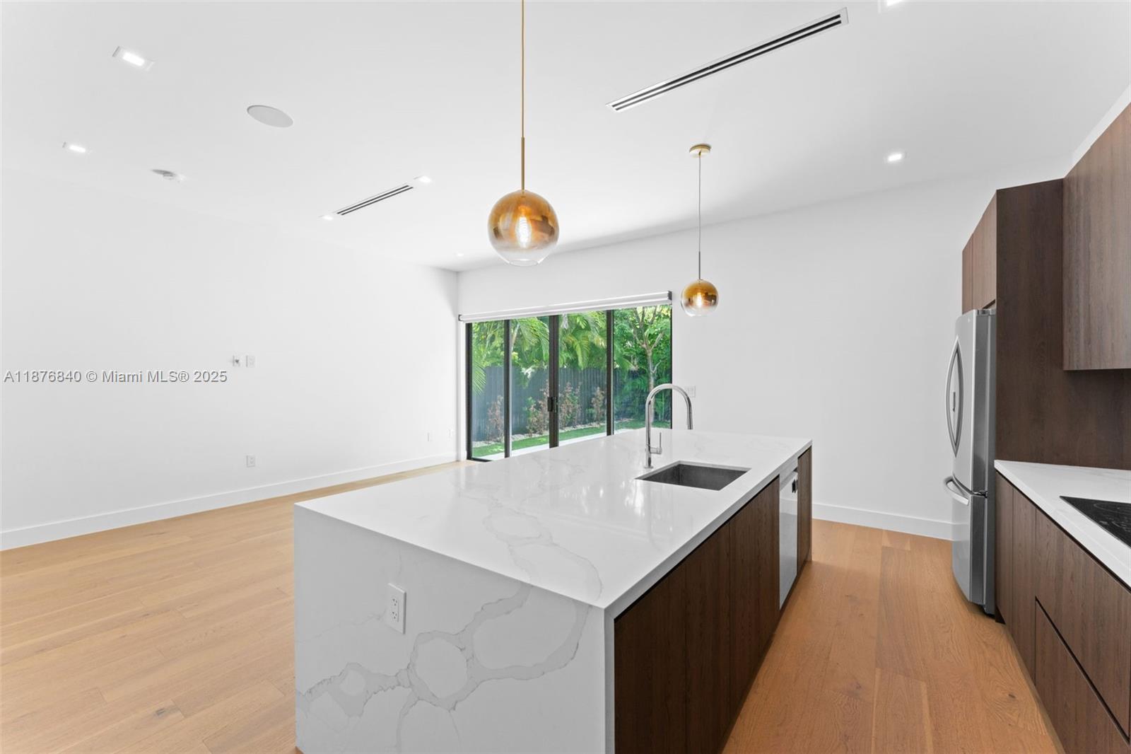 3132 Plaza Street Miami, FL 33133 - Photo 9 of 36 a kitchen with a refrigerator and a sink