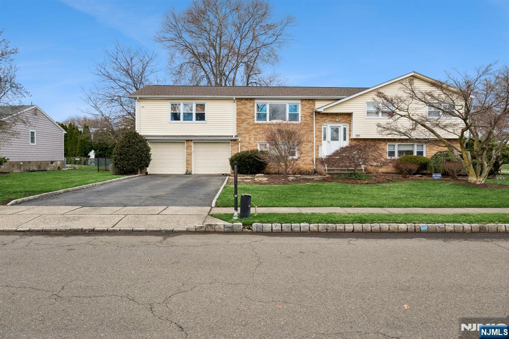 2 Caryn Place Fairfield, NJ 07004 - Photo 1 of 35 a front view of a house with a yard and garage