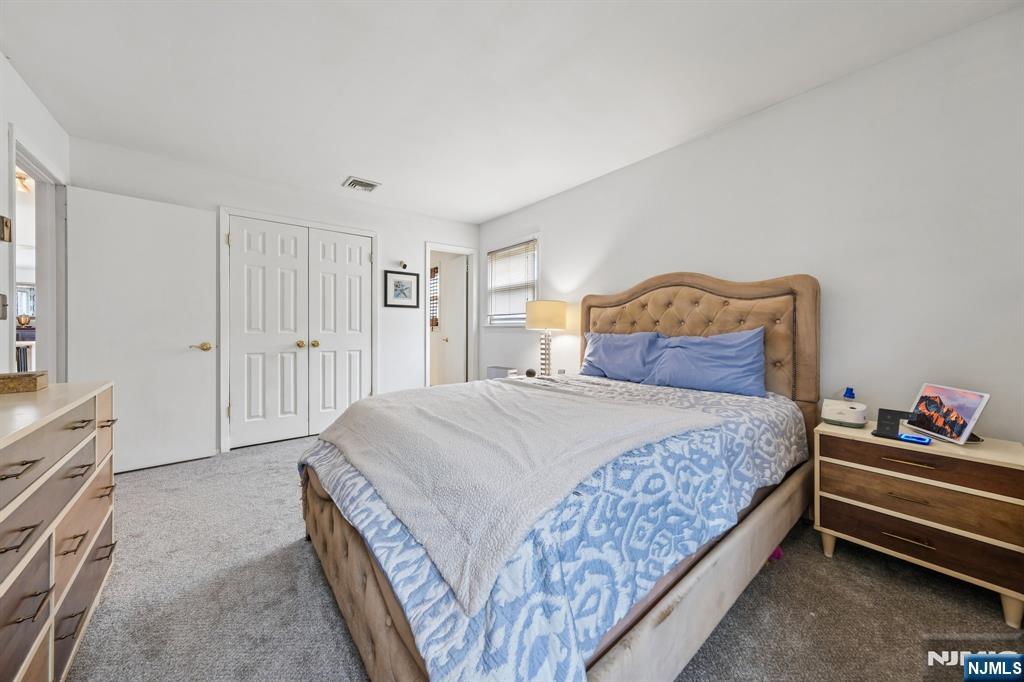 2 Caryn Place Fairfield, NJ 07004 - Photo 12 of 35 a bedroom with a bed and a cabinets