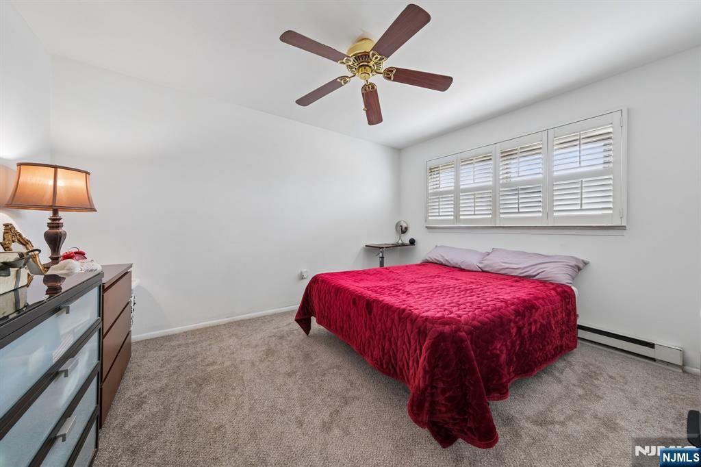 2 Caryn Place Fairfield, NJ 07004 - Photo 15 of 35 a spacious bedroom with a bed and a chandelier