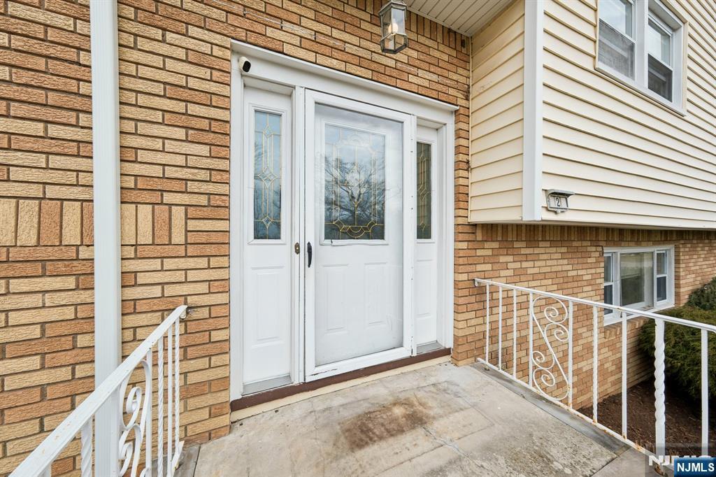 2 Caryn Place Fairfield, NJ 07004 - Photo 2 of 35 a view of a brick house with large windows