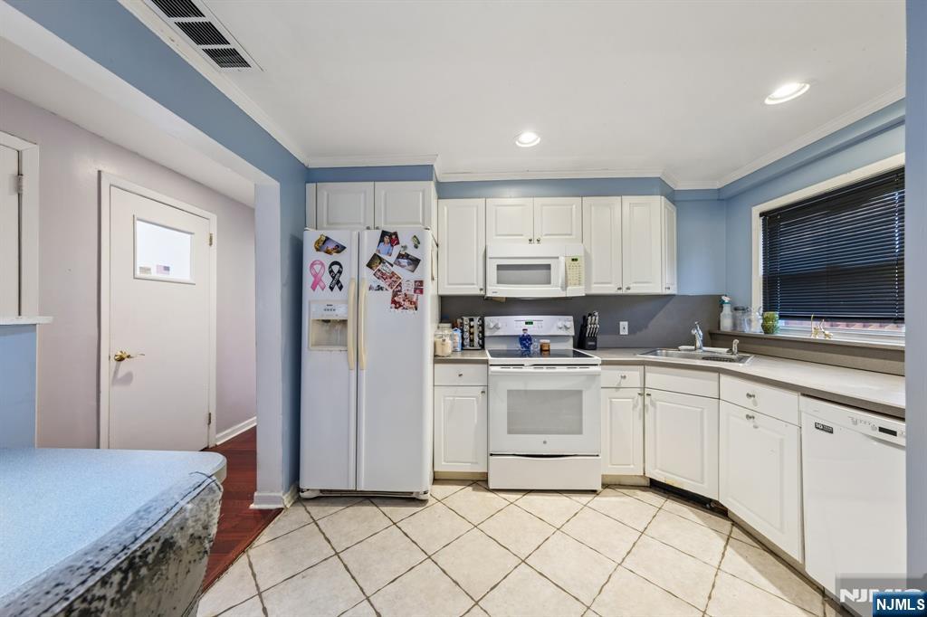 2 Caryn Place Fairfield, NJ 07004 - Photo 21 of 35 a kitchen with stainless steel appliances granite countertop a refrigerator and a stove top oven