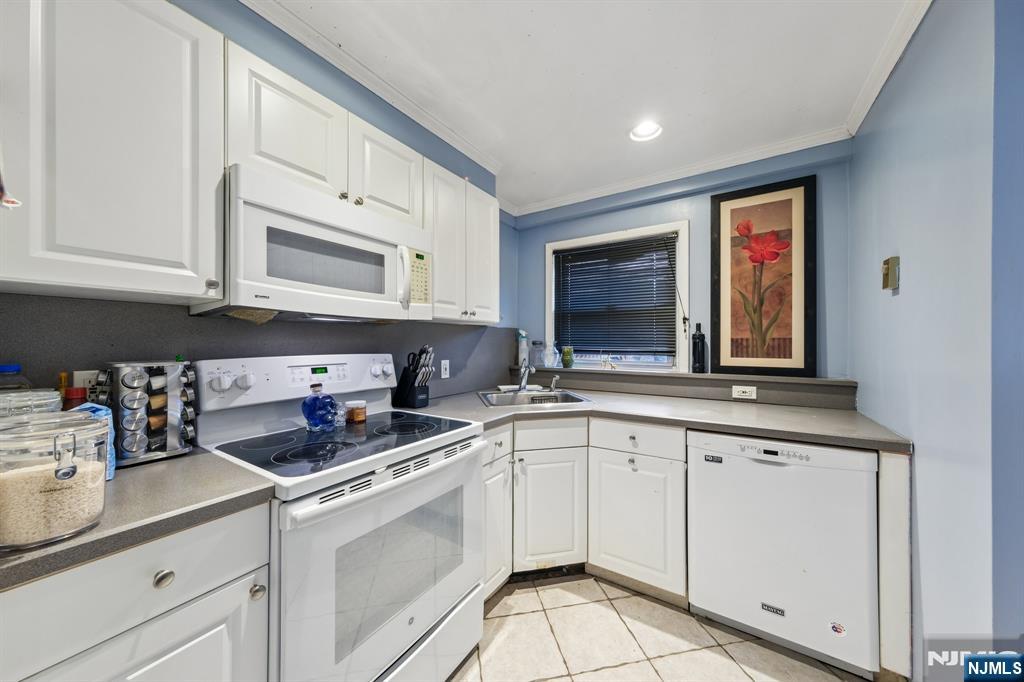 2 Caryn Place Fairfield, NJ 07004 - Photo 22 of 35 a kitchen with appliances cabinets and a sink