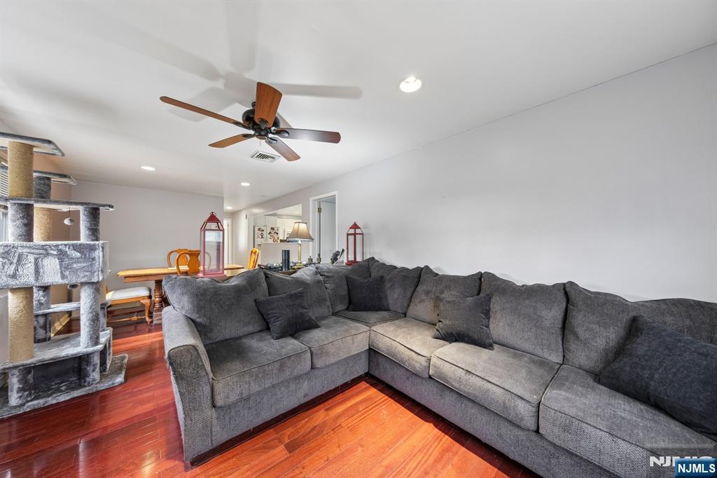 2 Caryn Place Fairfield, NJ 07004 - Photo 24 of 35 a living room with furniture a ceiling fan and a rug