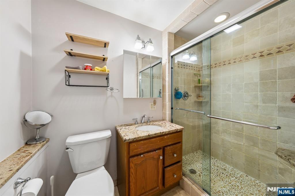 2 Caryn Place Fairfield, NJ 07004 - Photo 28 of 35 a bathroom with a sink toilet and shower