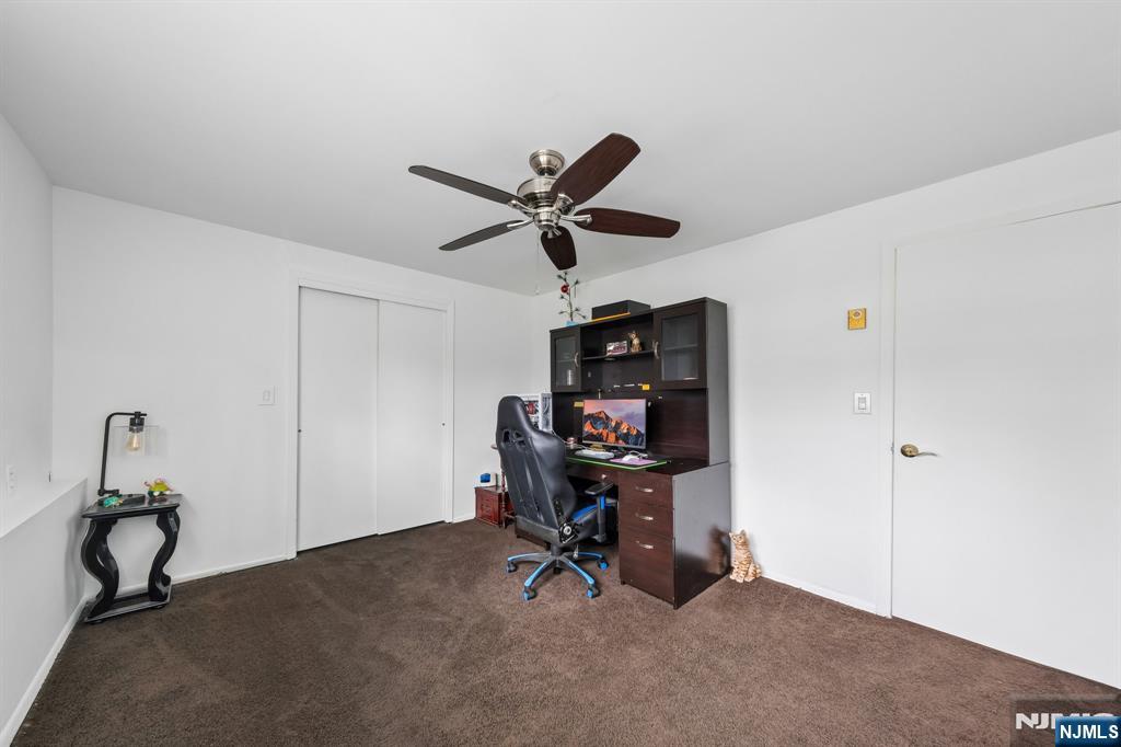2 Caryn Place Fairfield, NJ 07004 - Photo 30 of 35 a work room with table and a ceiling fan