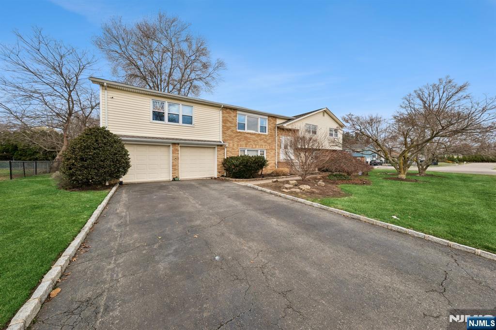 2 Caryn Place Fairfield, NJ 07004 - Photo 35 of 35 a front view of a house with a yard and garage