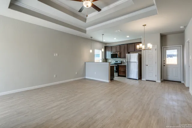 a view of a kitchen with a sink and a refrigerator