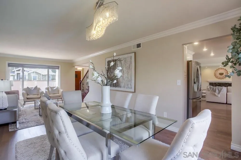 13495 Mango Drive Del Mar, CA 92014 - Photo 11 of 53 a dining room with wooden floor a chandelier a glass table and chairs