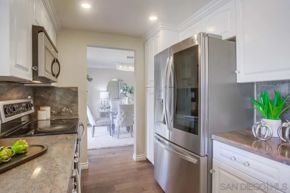 13495 Mango Drive Del Mar, CA 92014 - Photo 24 of 53 a kitchen with stainless steel appliances granite countertop a refrigerator and a sink