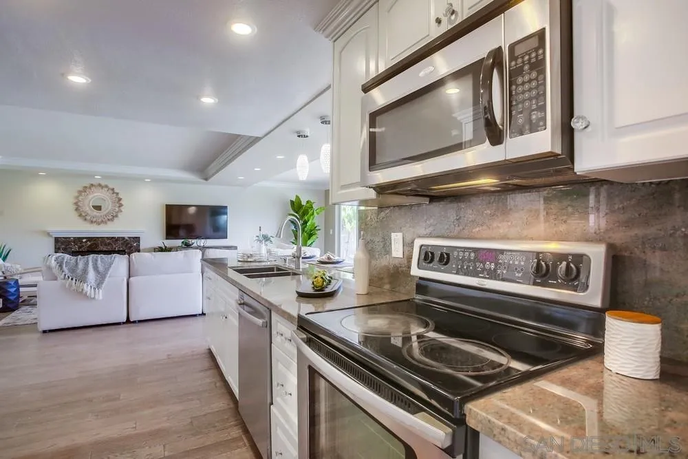 13495 Mango Drive Del Mar, CA 92014 - Photo 25 of 53 a kitchen with stainless steel appliances granite countertop a stove a microwave and a sink