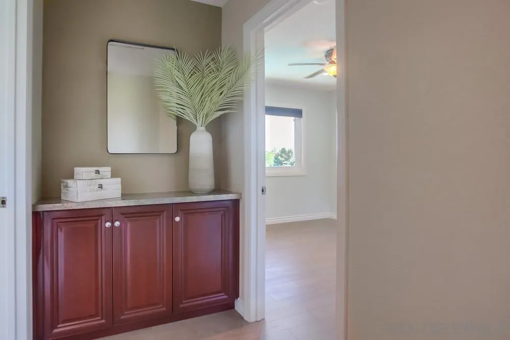 13495 Mango Drive Del Mar, CA 92014 - Photo 30 of 53 a bathroom with a granite countertop sink a potted plant and a mirror