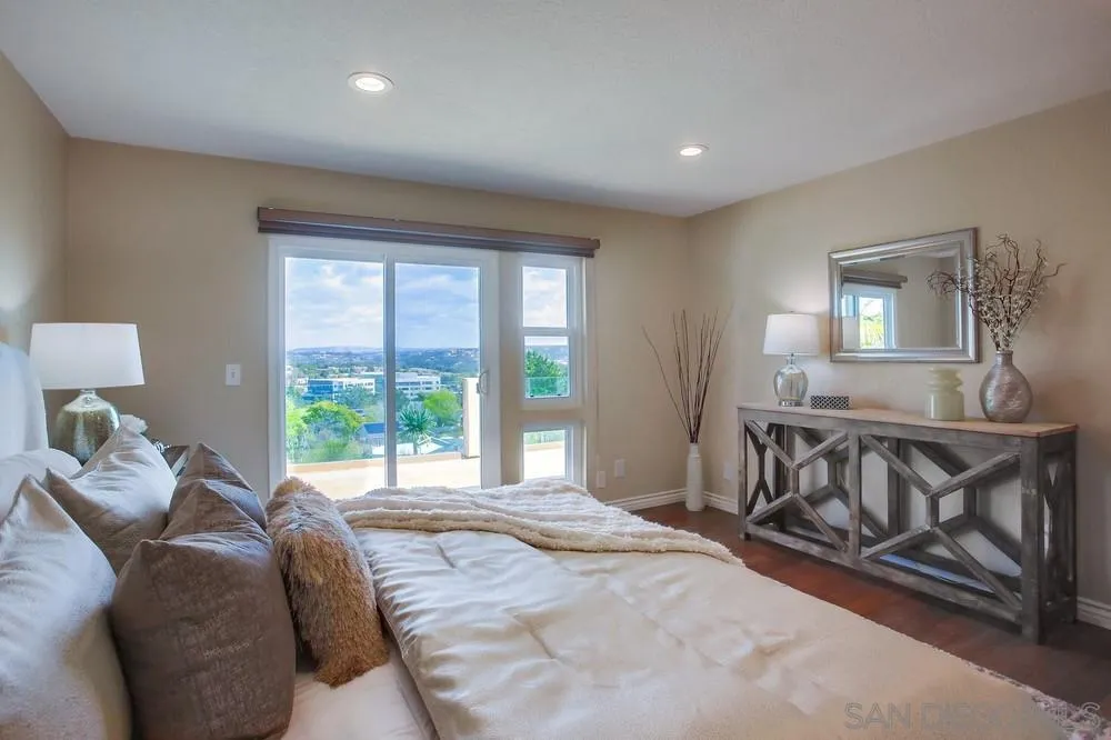 13495 Mango Drive Del Mar, CA 92014 - Photo 32 of 53 a spacious bedroom with a bed and a window