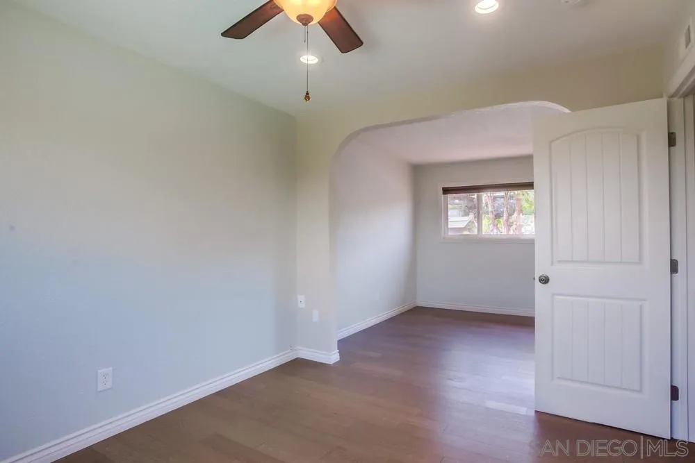 13495 Mango Drive Del Mar, CA 92014 - Photo 40 of 53 an empty room with a window and a ceiling fan