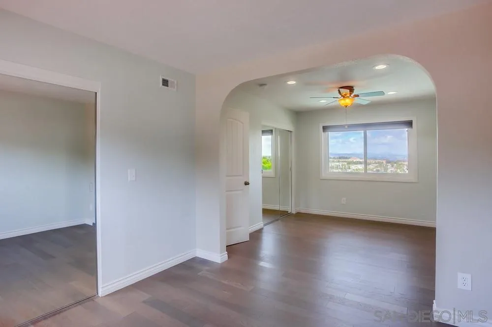 13495 Mango Drive Del Mar, CA 92014 - Photo 42 of 53 an empty room with wooden floor and windows
