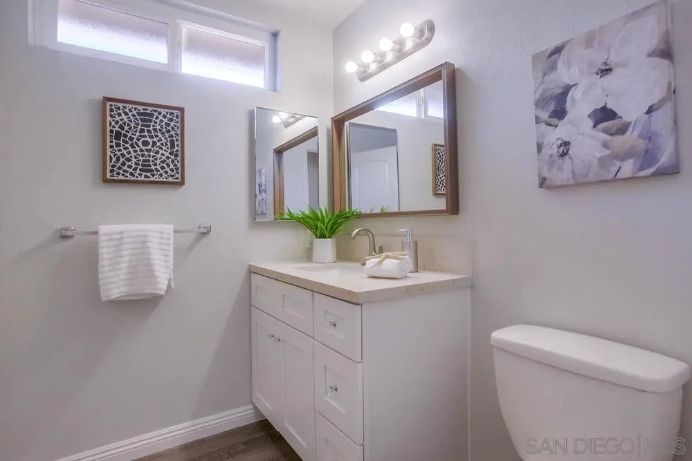13495 Mango Drive Del Mar, CA 92014 - Photo 45 of 53 a bathroom with a toilet sink and mirror