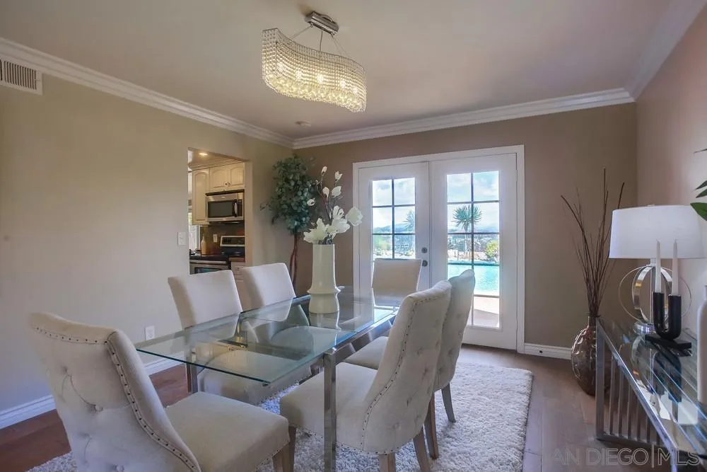13495 Mango Drive Del Mar, CA 92014 - Photo 9 of 53 a dining room with furniture a chandelier and window