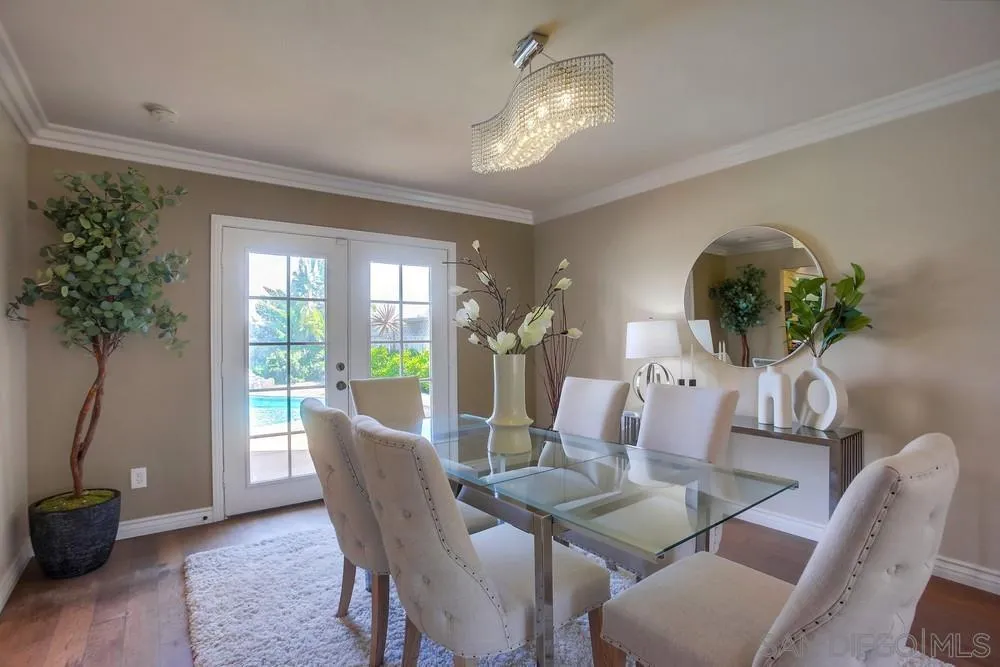 13495 Mango Drive Del Mar, CA 92014 - Photo 10 of 53 a dining room with furniture potted plants and wooden floor